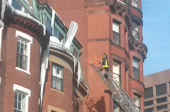 Firefighter takes on a giant icicle on Beacon Hill
