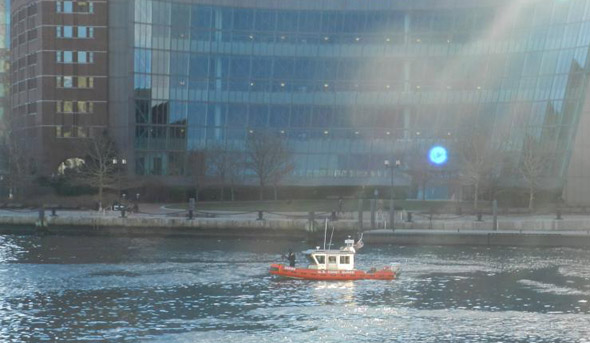 Coast Guard patrols Boston Harbor near the federal courthouse