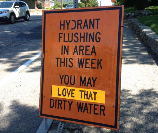 Hydrant flushing sign in Braintree: Love that dirty water