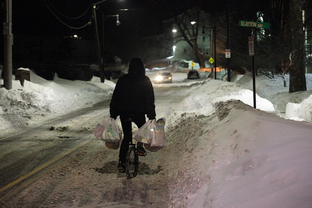Man on a unicycle in the snow in Jamaica Plain