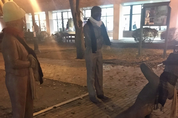 Bundled up statues in Davis Square in Somerville