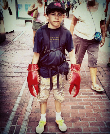 Kid with lobster claws in downtown Boston
