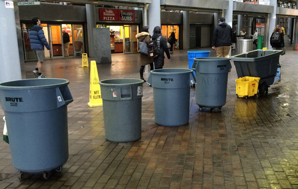 Trash barrels used to collect rain at Ruggles station on the Orange Line