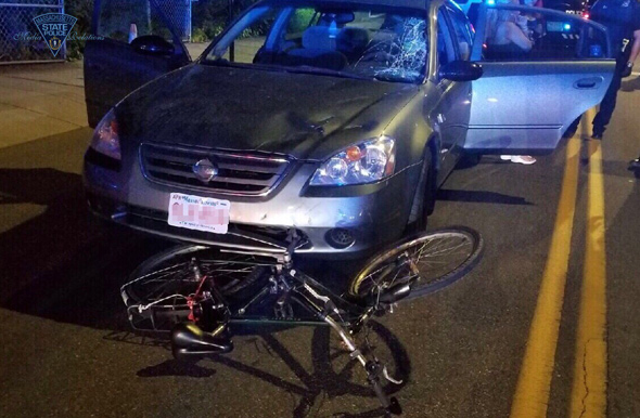 Car in Everett with bicycle wedged in front