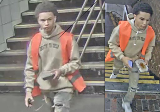 Suspect wearing orange safety vest