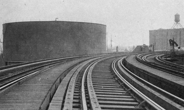 Molasses tank as seen from elevated railroad along Commercial Street