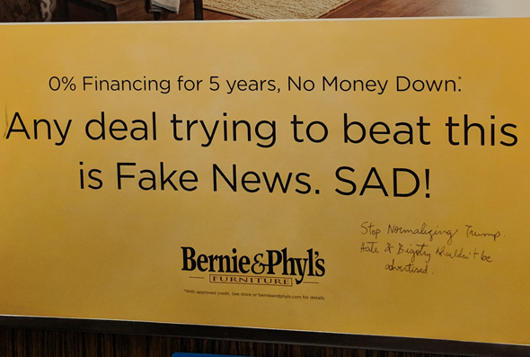 Bernie and Phylls ad that clals other deals Fake News is met with pen scrawl asking them to stop normalizing Trump