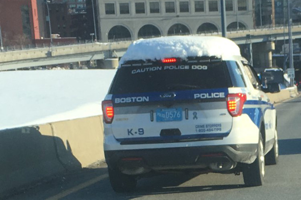 Snow-covered Boston Police cruiser on the Southeast Expressway