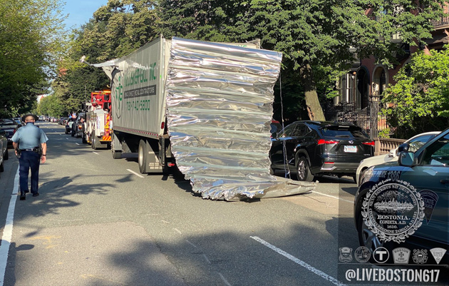 Box truck with peeled-back roof after hitting a bridge on Storrow Drive
