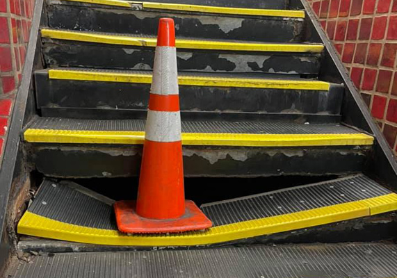 Broken Park Street step with cone
