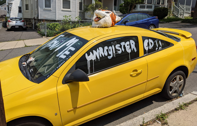 Abandoned car with a tiger head on it