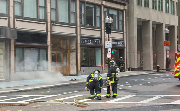 Firefighters at manhole explosion scene