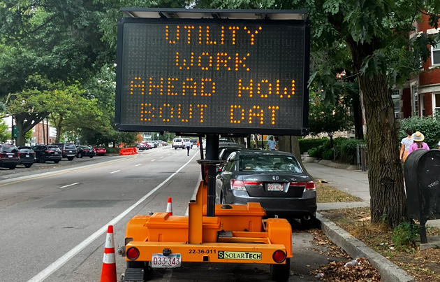 Sign board reading: Utility work ahead how bout dat