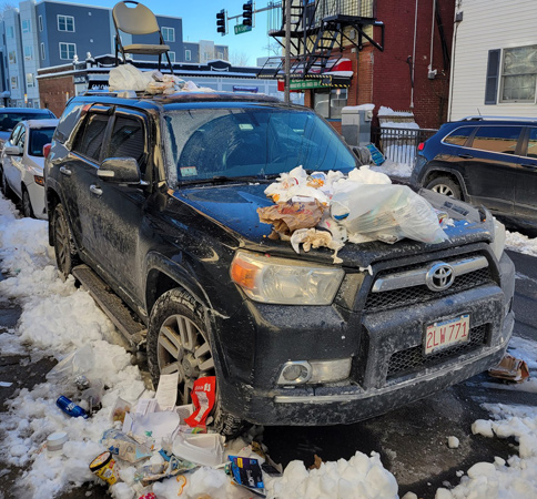 Car with trash on it in South Boston