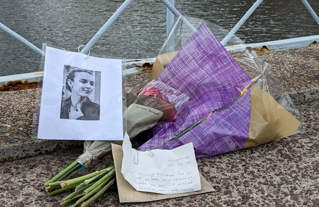 Two bouquets, a note and a photo on the Public Garden bridge