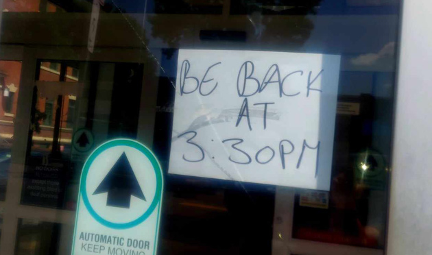 Sign on the door of the closed Codman Square post office: Be back at 3:30 p.m.