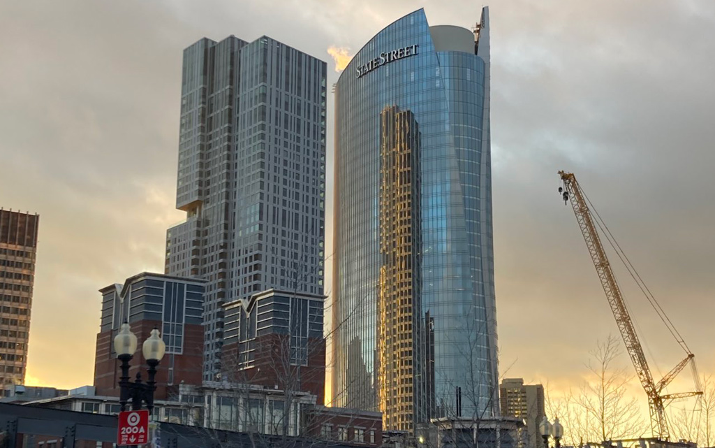 New State Street building reflects neighboring building as sun goes down