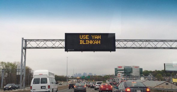 Highway sign telling drivahs to use theyah blinkahs