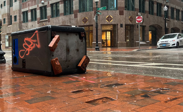 Big Belly trash receptacle pushed over by wind on State Street