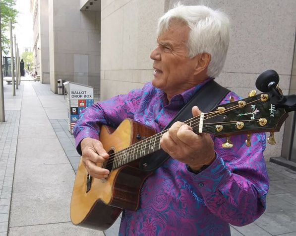 John Davidson with a guitar on Boylston Street outside the BPL