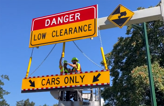 New bright-yellow CARS ONLY sign being installed at Storrow Drive entrance
