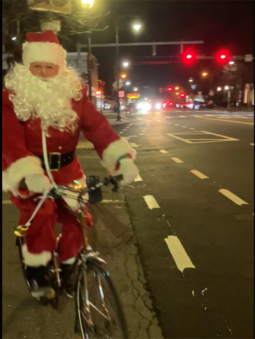 Biking Santa on Centre Street in West Roxbury