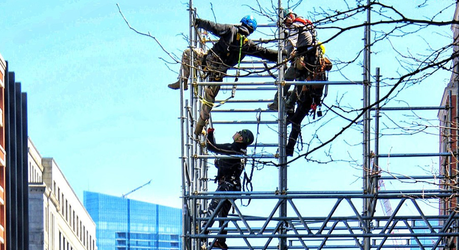 Workers erecting scaffolding at the Boston Marathon finish line