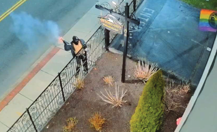 Surveillance photo of suspect throwing a pipe bomb