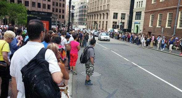 People waiting for a bus on State Street due to Blue Line problems