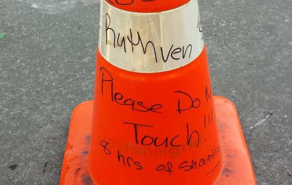 Eight hours of shoveling marked on a cone on Ruthven Street in Roxbury