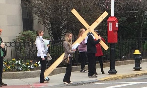 Man with a cross on Longwood Avenue