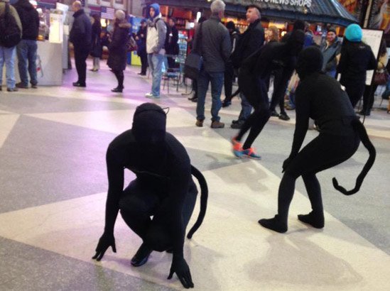 Black-clad dancers in Boston's South Station