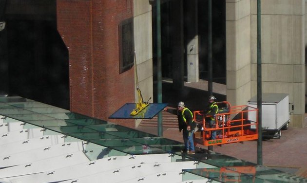 Installing glass at the new Government Center subway station