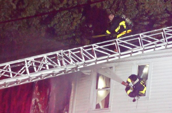 FIrefighters working to put out fire on Kittredge Street in Roslindale