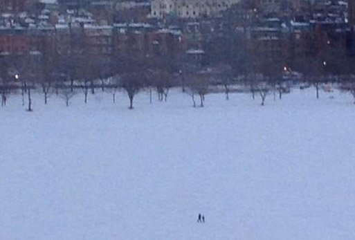 Adult and child on the Charles River