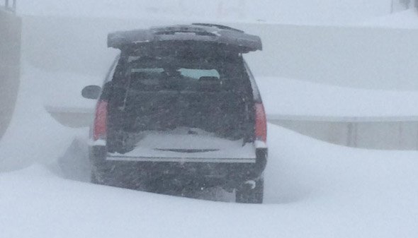 SUV with rear opened in a blizzard