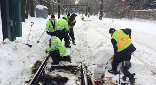 MBTA workers on the Green Line in the snow