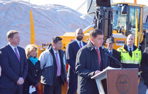 Marty Walsh in front of a giant sand pile talking about snow in Boston