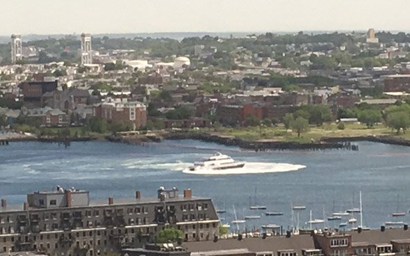 Boat doing donuts in inner Boston Harbor