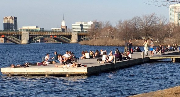 People on a dock in the Charles River in Boston