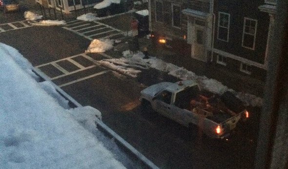 Boston workers picking up space savers after snow storm