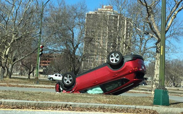 Red car flipped on Soldiers Field Drive in Brighton