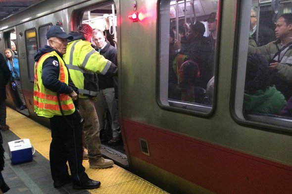 Workers trying to fix door on a Red Line train in Boston