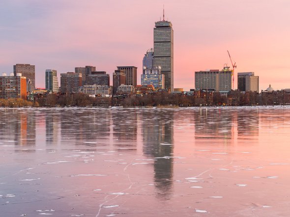 Boston skyline at sunset with ice on the Charles
