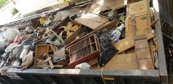 Dumpster full of contents from 97 Mt. Ida Rd.