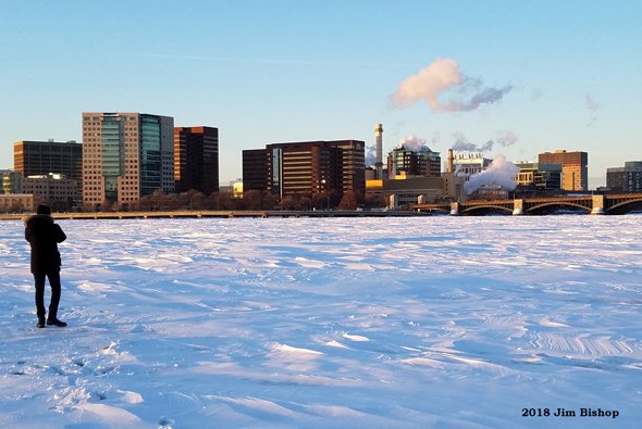 Man standing on ice on the Charles River