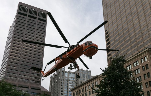Orange helicopter hovers in downtown Boston
