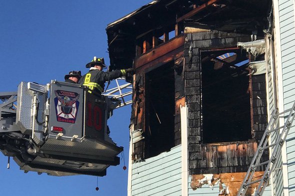 Firefighters inspect 688 Columbia Rd, in Dorchester after fire is knocked down