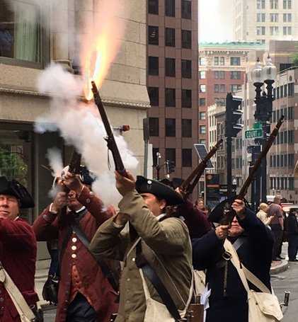 Minutemen firing muskets in downtown Boston
