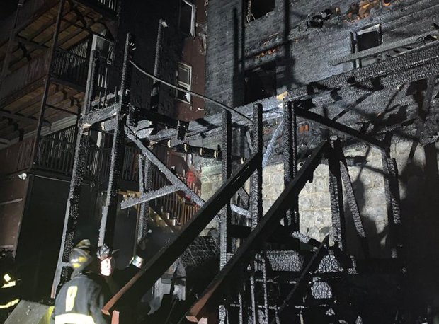 Firefighters at one charred building